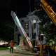 Crew members work to remove the 30-foot Confederate monument which is been brought down on June 19, 2020, in Decatur northeast of Atlanta, Georgia. - Hundreds of people cheered as crews worked to move the Confederate monument from Decatur Square on the eve of Juneteenth.